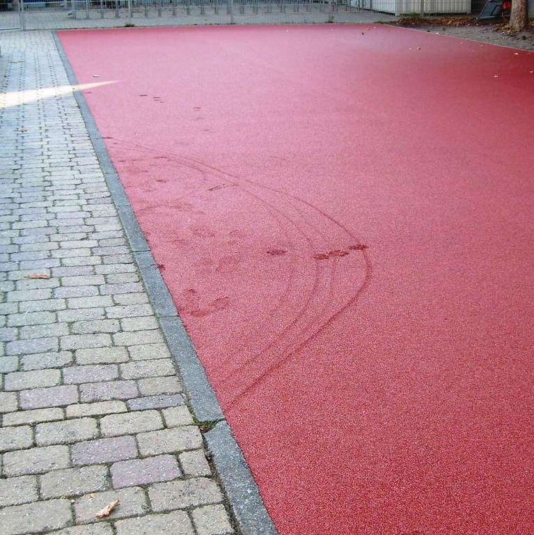 Schaden Tartanbahn